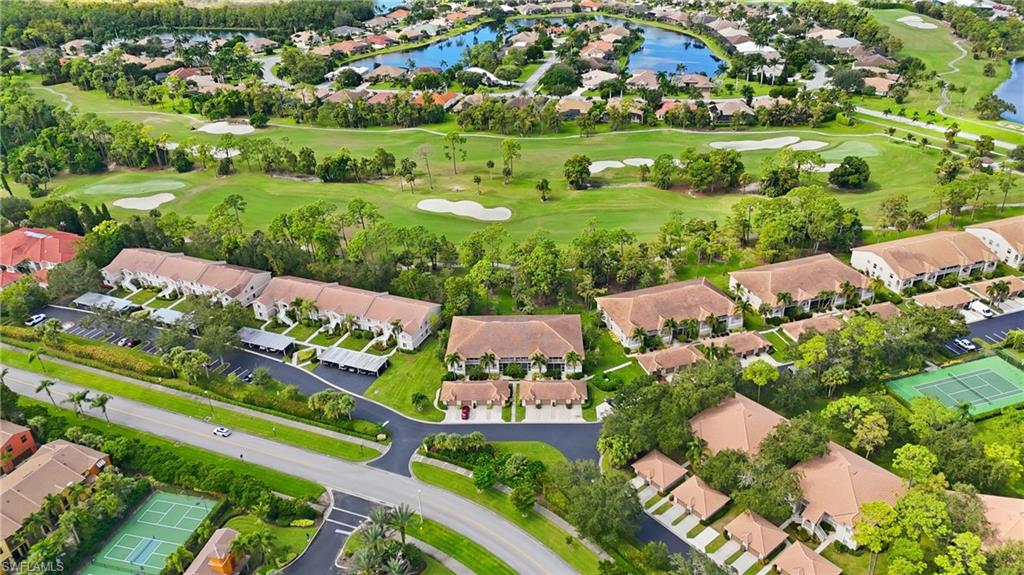 Aerial overview of property's location featuring nearby suburban area, a golf club, and a nearby body of water