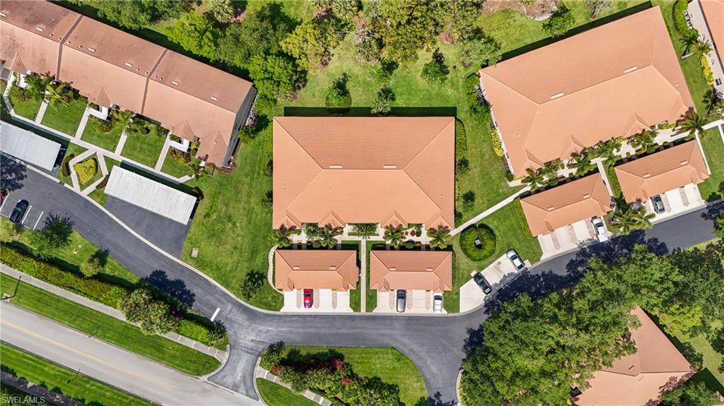 Aerial perspective showcasing a residential community with multiple buildings featuring terracotta-style roofing
