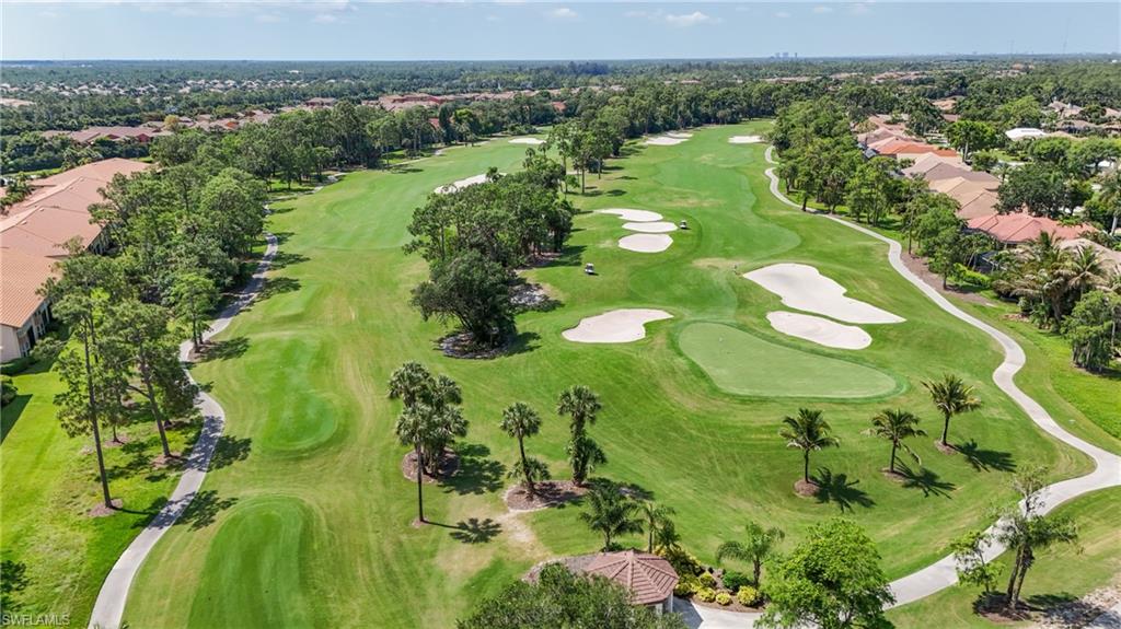 Expansive golf course featuring manicured greens and fairways, sand traps, and mature trees