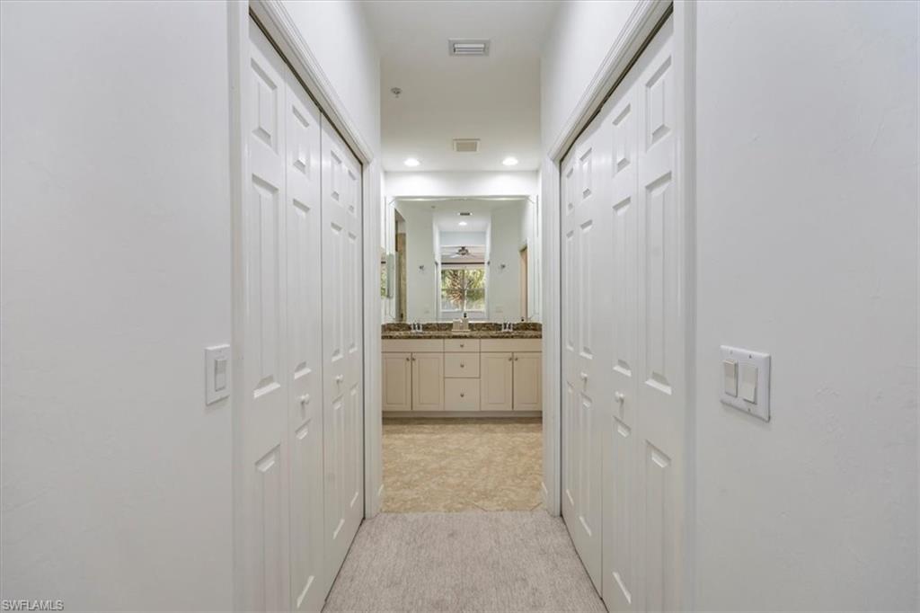 Corridor featuring recessed lighting and dual closets