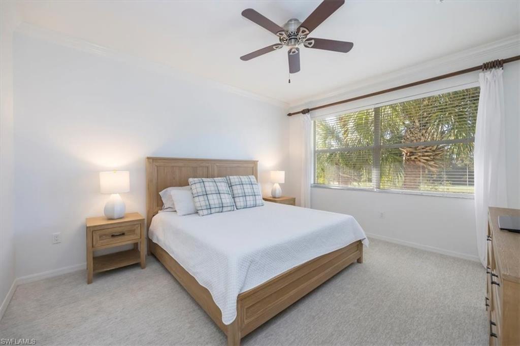 Carpeted bedroom featuring crown molding and ceiling fan and King size bed
