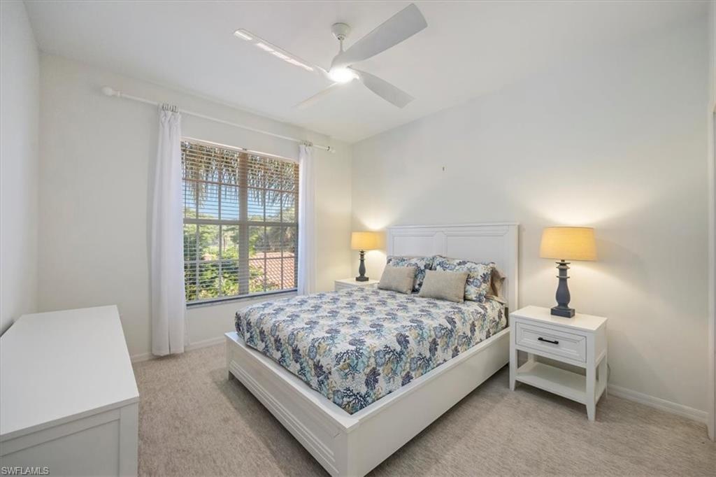Bedroom featuring light colored carpet and ceiling fan and Queen size bed