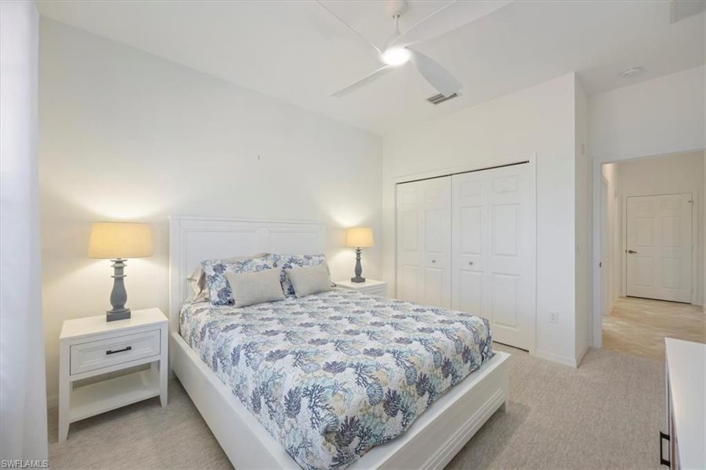 Bedroom featuring light colored carpet and ceiling fan and Queen size bed