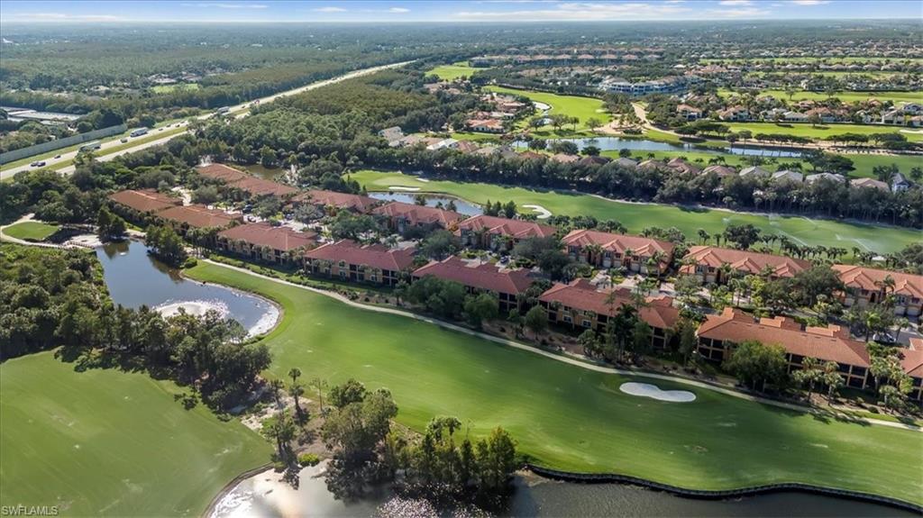 Aerial view of residential area featuring a large body of water and a local golf course