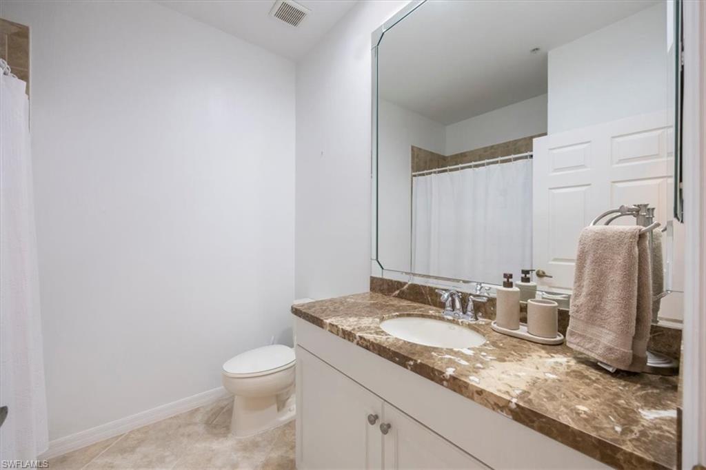 Bathroom featuring vanity, a shower with shower curtain, and light tile patterned floors