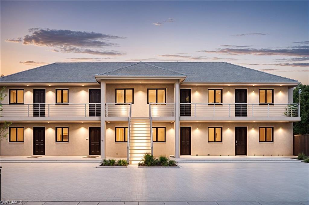 View of front of house featuring stucco siding, driveway, and a shingled roof