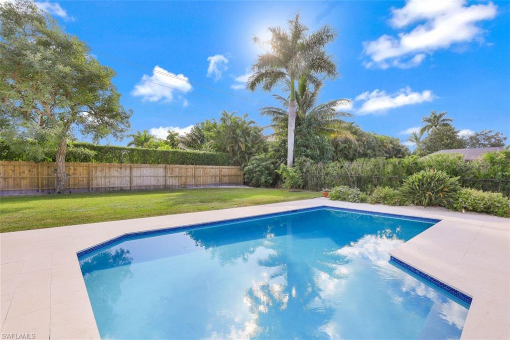 View of pool with a fenced backyard and a patio