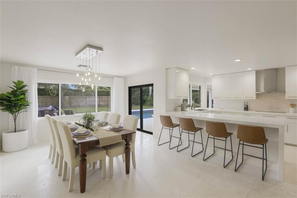 Dining area with recessed lighting and a chandelier