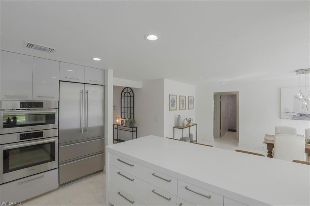 Kitchen featuring white cabinets, stainless steel appliances, recessed lighting, modern cabinets, and pendant lighting