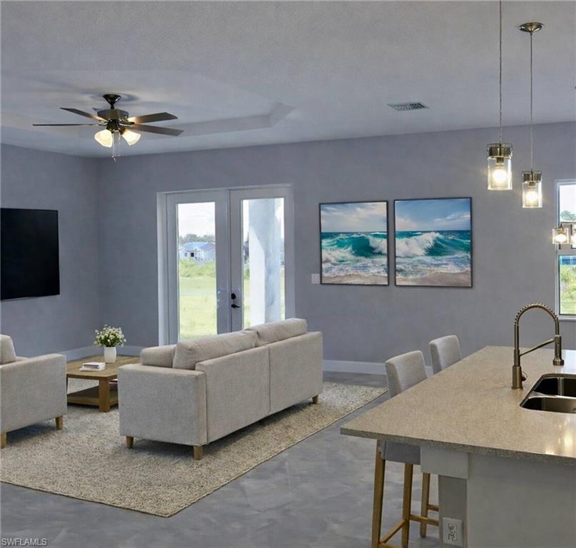 Living room featuring a ceiling fan, healthy amount of natural light, and french doors