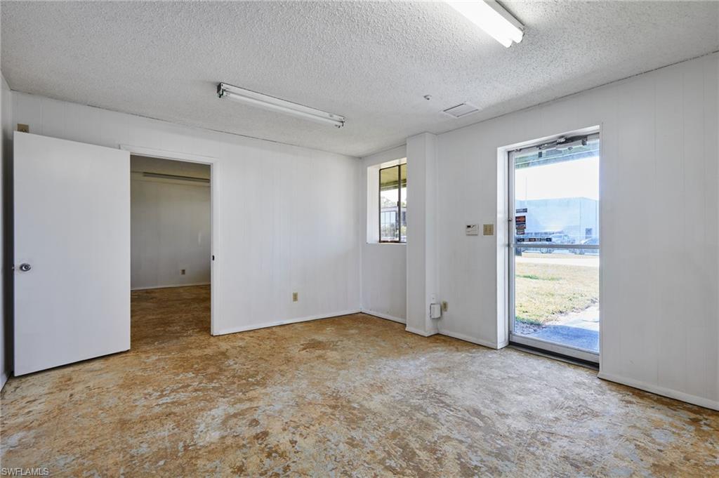 Spare room featuring a textured ceiling and baseboards