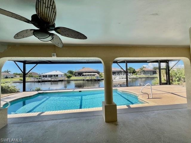 Outdoor pool featuring a lanai, a water view, a ceiling fan, and a sunroom