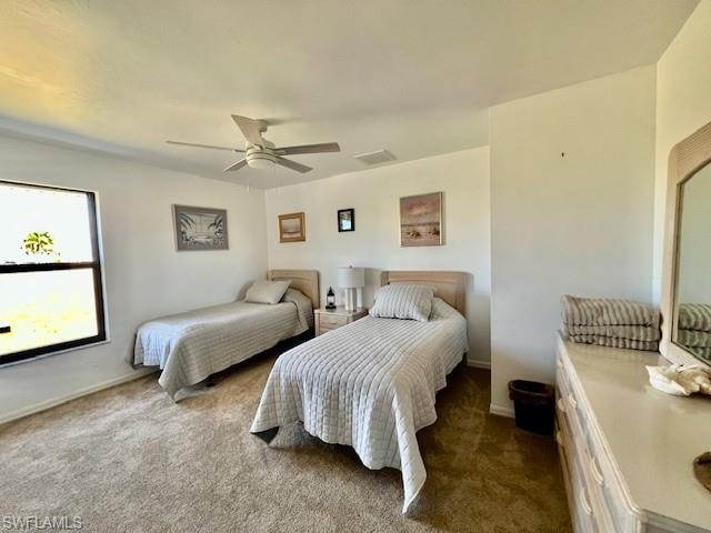 Bedroom with dark colored carpet and a ceiling fan