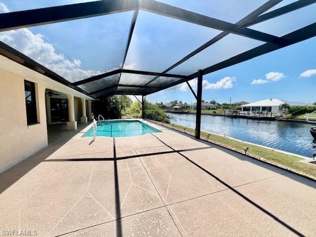 Outdoor pool with a sunroom, a patio, a water view, and glass enclosure