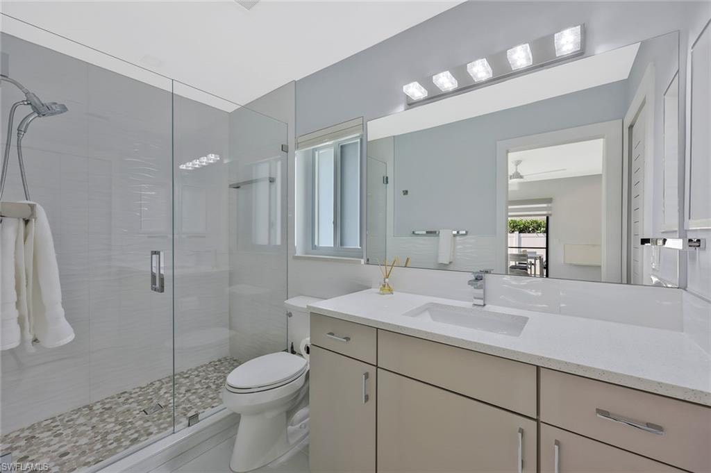 Full bath featuring vanity and a shower stall