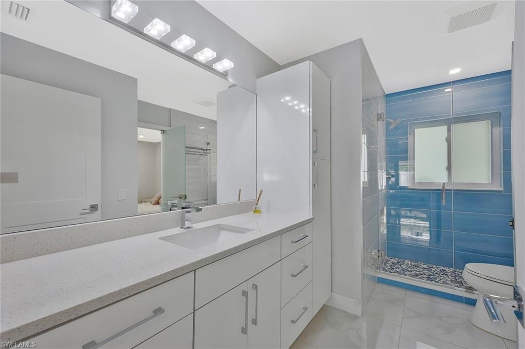 Bathroom with vanity and a shower stall