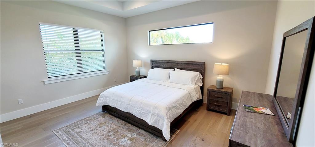 Bedroom featuring light wood-style flooring and baseboards