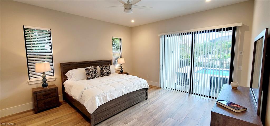 Bedroom with wood finished floors, access to outside, recessed lighting, and ceiling fan