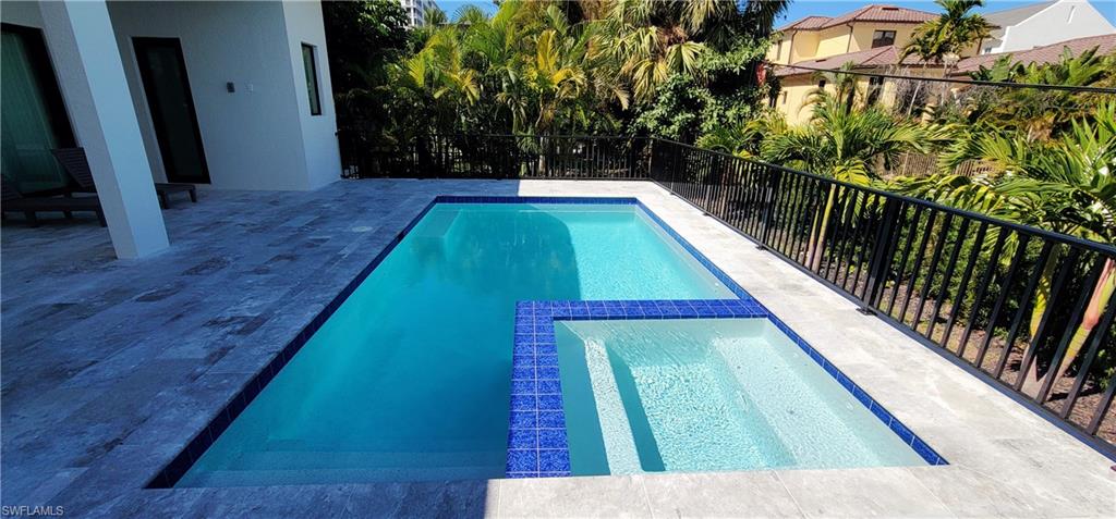 View of pool with a pool with connected hot tub
