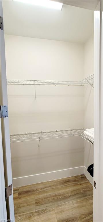 Walk in closet featuring light wood-type flooring
