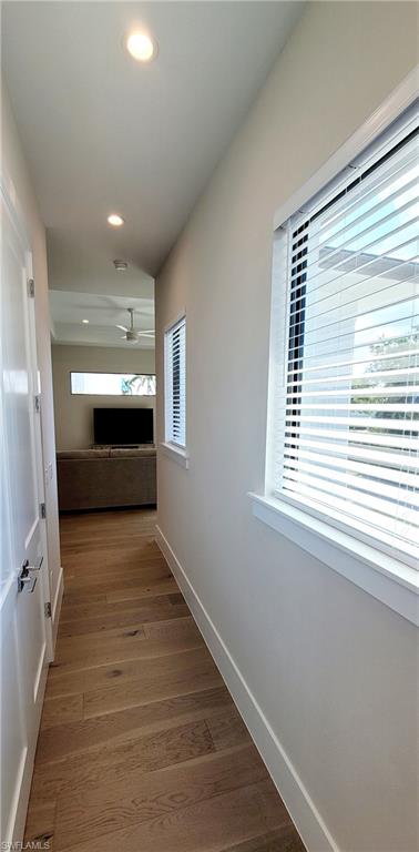 Hall with recessed lighting and light wood-style floors