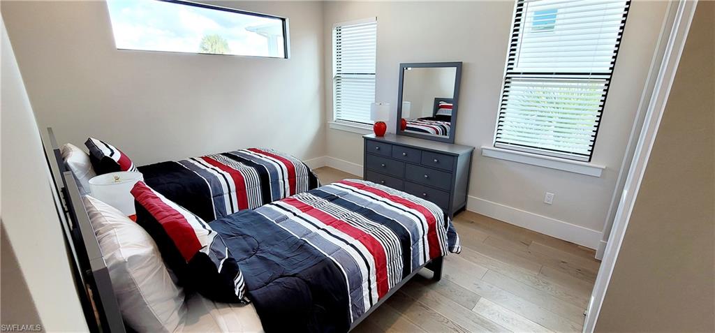 Bedroom featuring baseboards and light wood finished floors