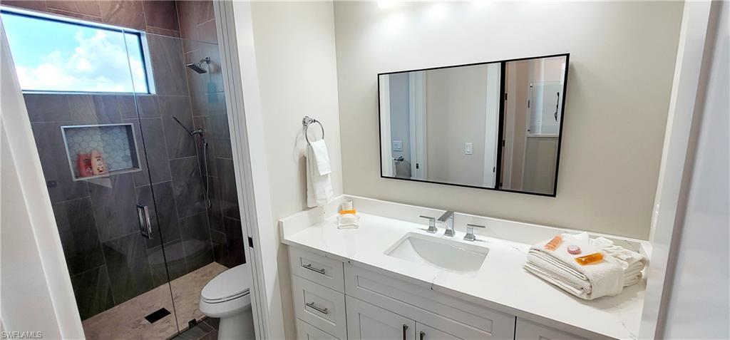 Bathroom featuring vanity, a shower stall, and tile patterned flooring