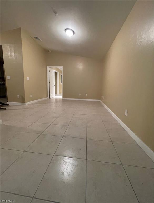 Spare room with light tile patterned floors and baseboards