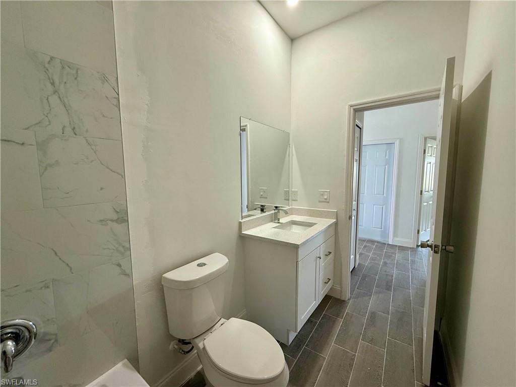 Full bath with wood tiled floors and vanity
