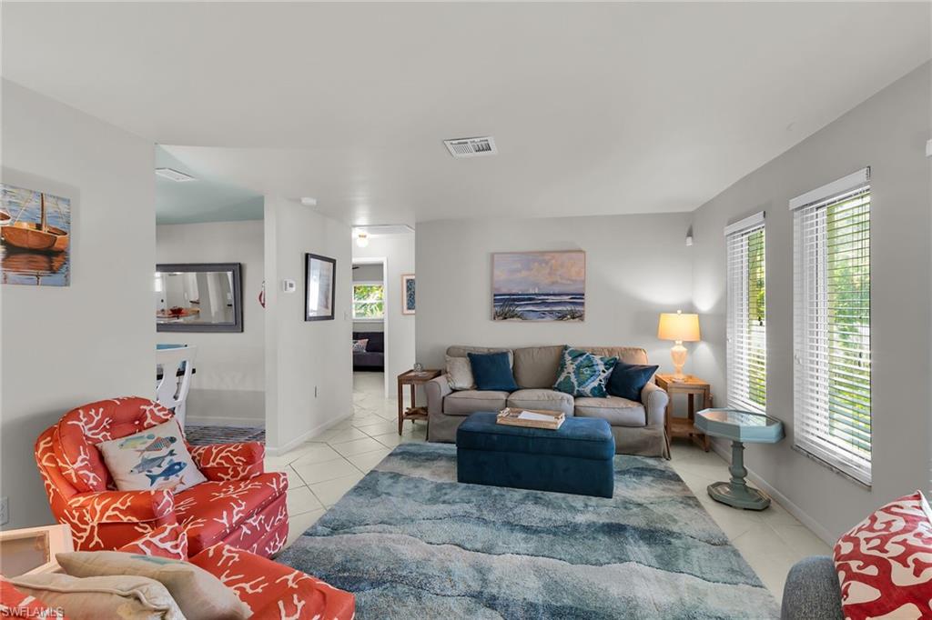 Living area featuring light tile patterned floors and healthy amount of natural light