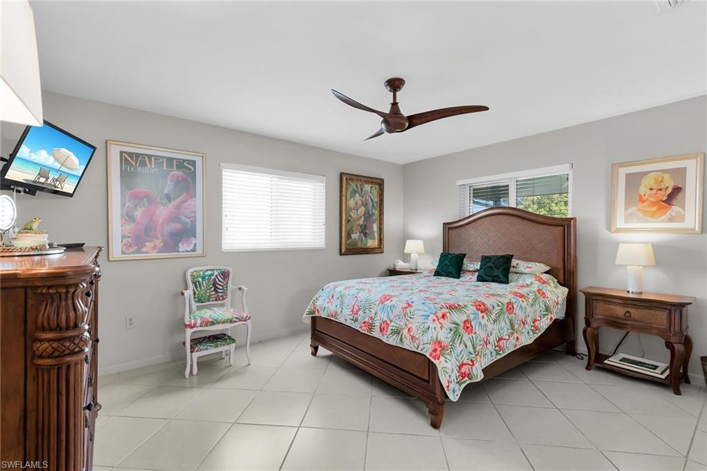 Bedroom with ceiling fan and light tile patterned floors