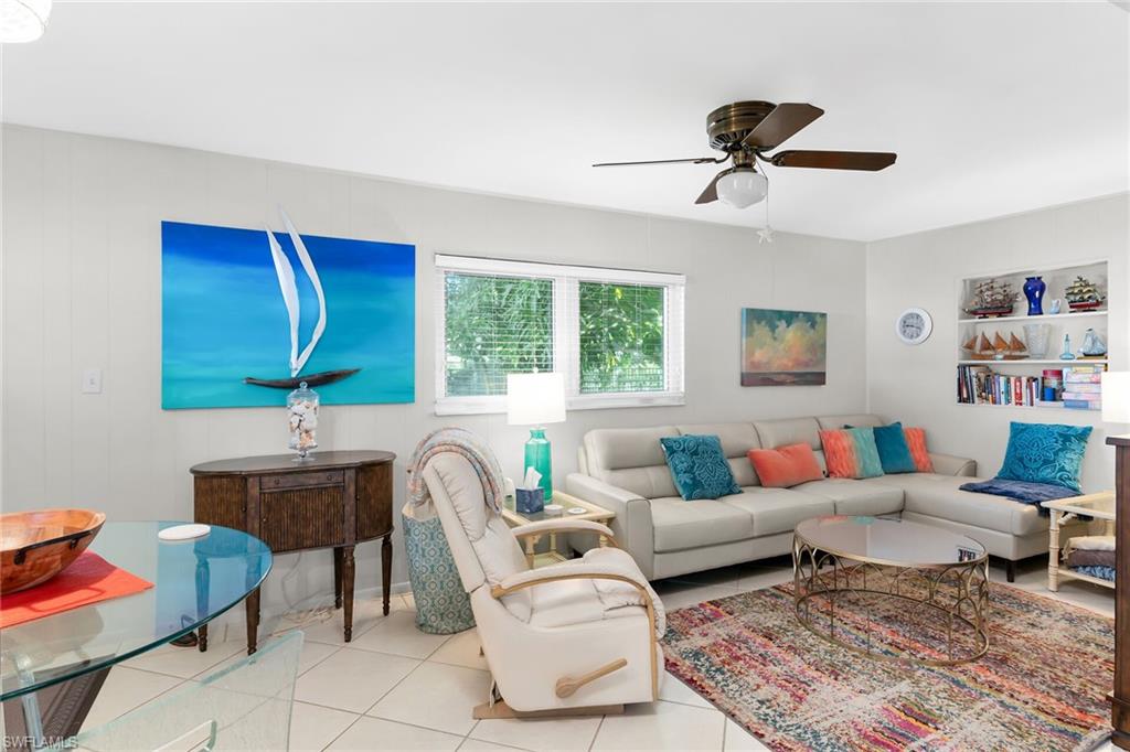 Living room with tile patterned floors and ceiling fan