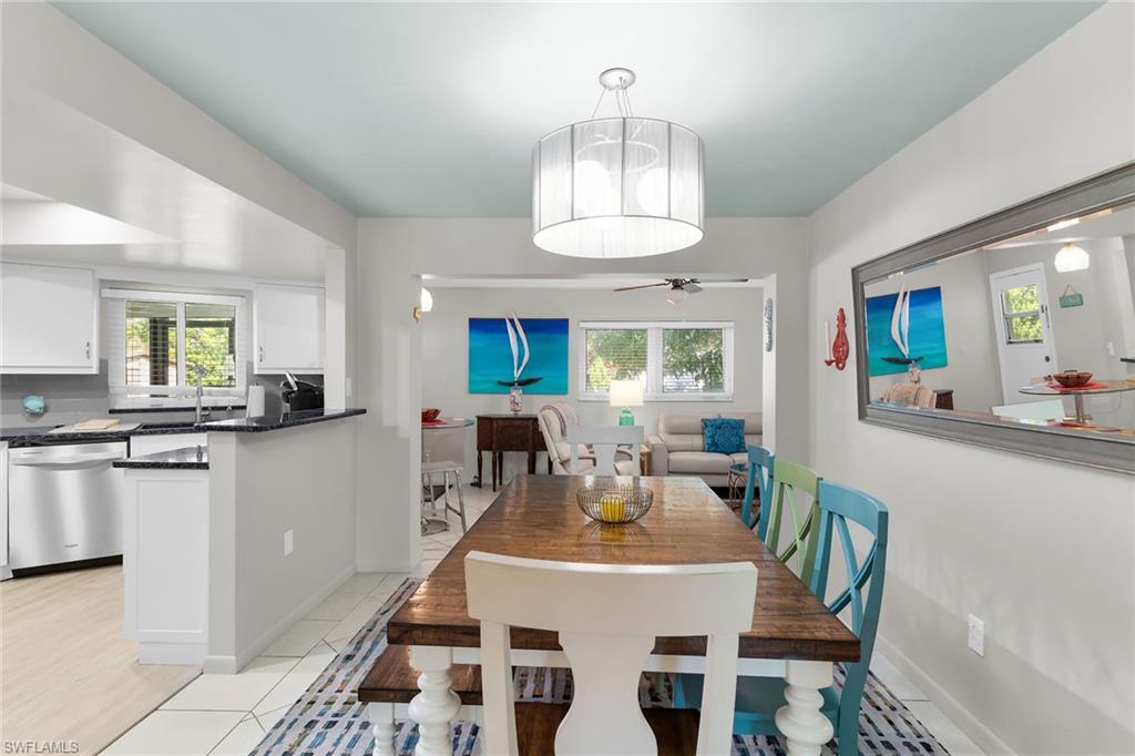Dining room featuring light tile patterned floors and a ceiling fan