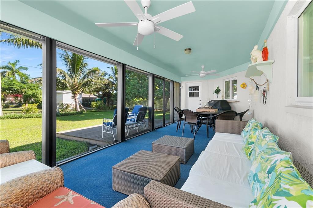 Sunroom / solarium with an outdoor hangout area, plenty of natural light, and a ceiling fan