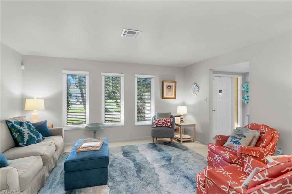Living room with plenty of natural light and tile patterned flooring