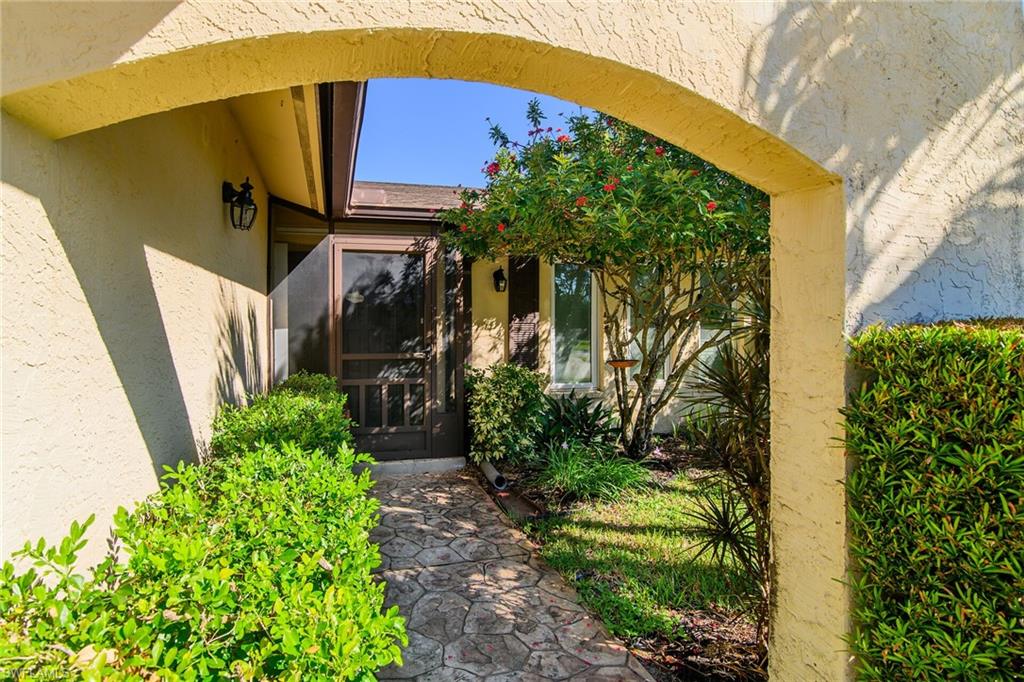 Entrance to property featuring stucco siding and a sunroom