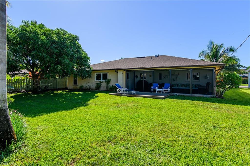 Rear view of property with stucco siding and a sunroom