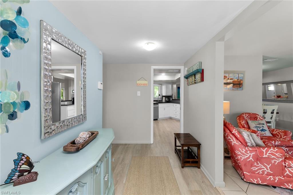 Hallway featuring light wood-style floors and baseboards