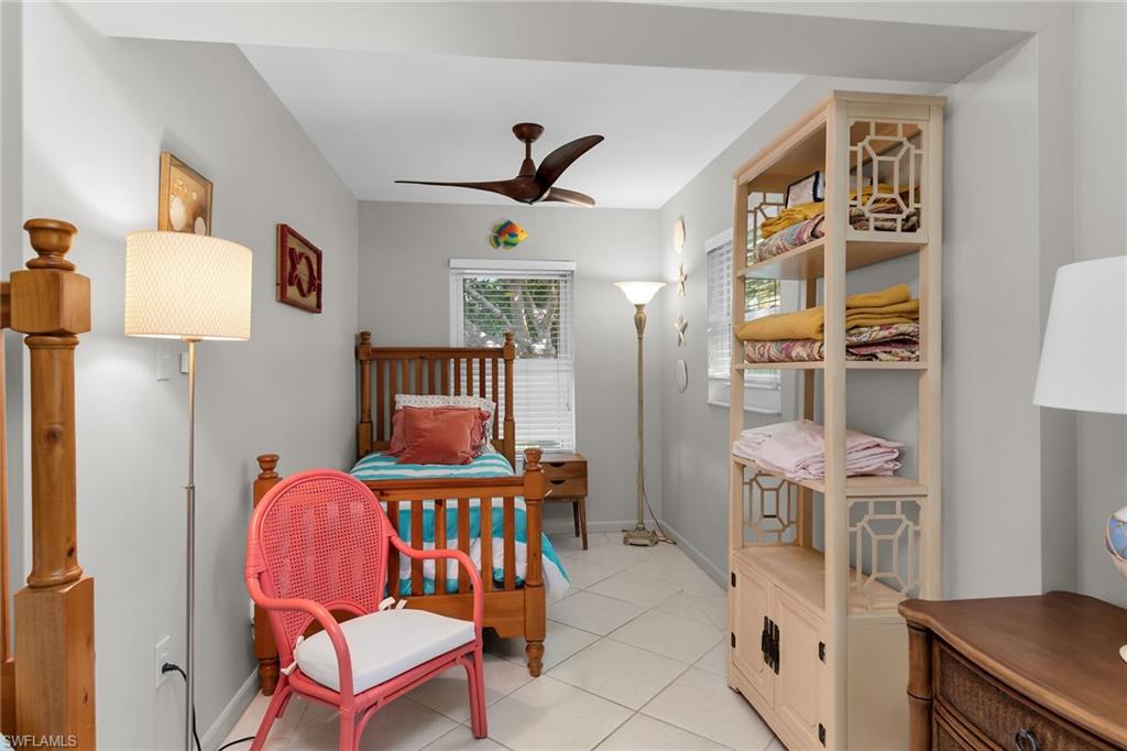 Bedroom featuring light tile patterned floors and a ceiling fan