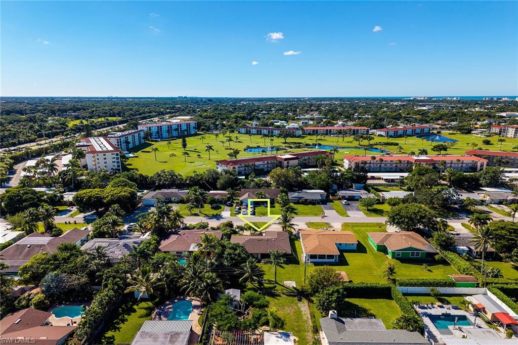 Aerial view of apartment complex / building and a golf course