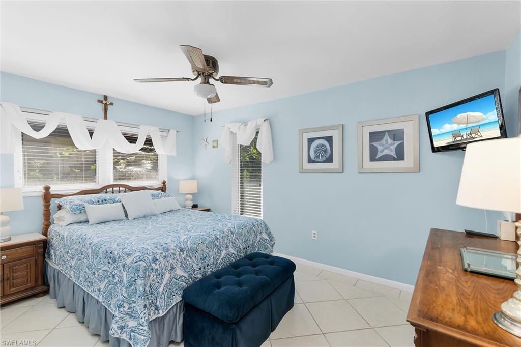 Bedroom featuring light tile patterned floors and a ceiling fan