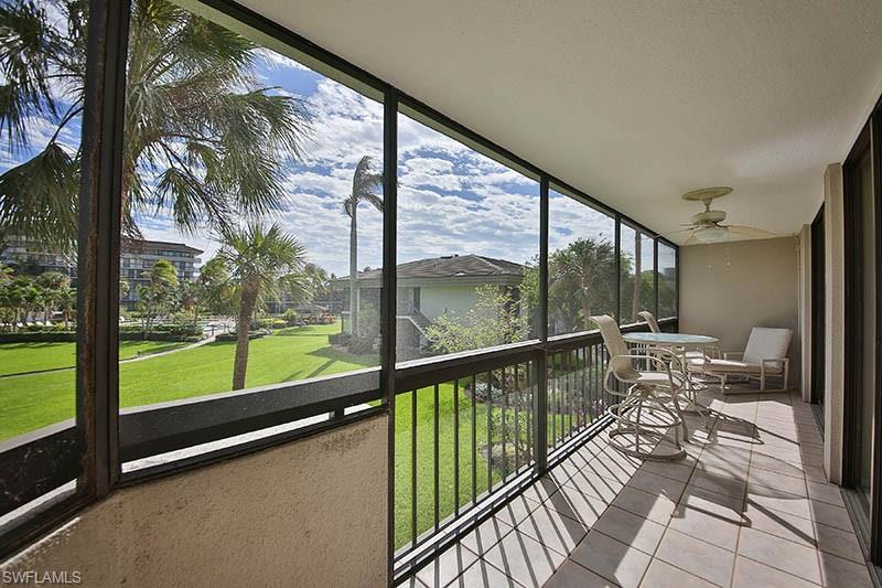 Unfurnished sunroom featuring ceiling fan and a balcony