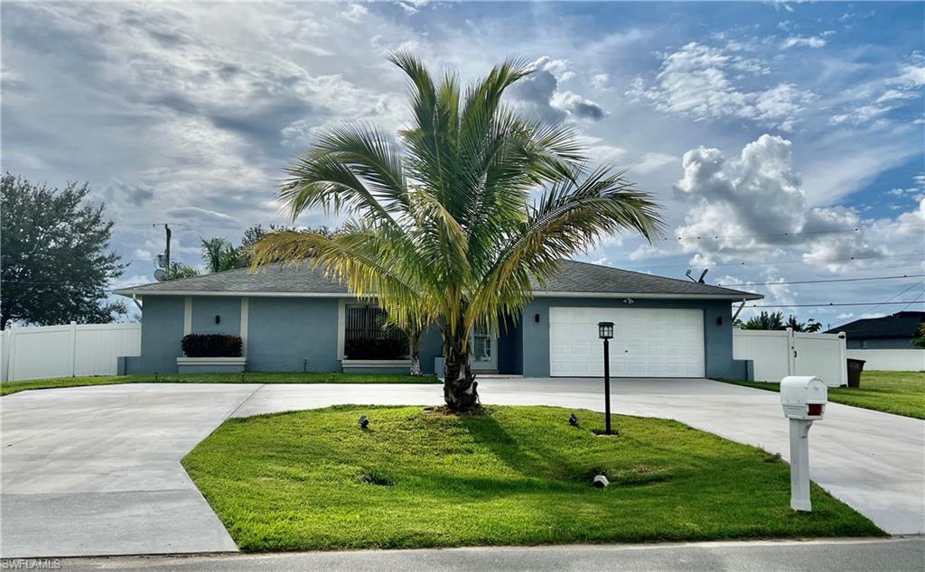 Single story home with curved driveway, stucco siding, and roof with shingles