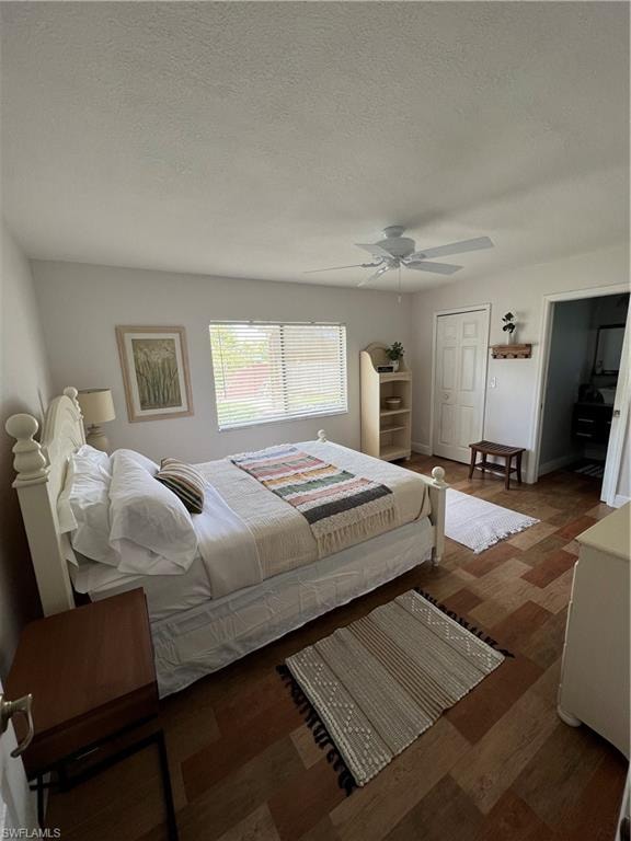 Bedroom featuring wood finished floors, a textured ceiling, and ceiling fan