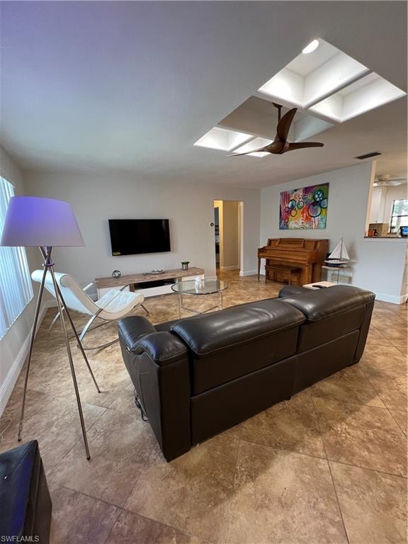 Living area with ceiling fan and tile patterned flooring