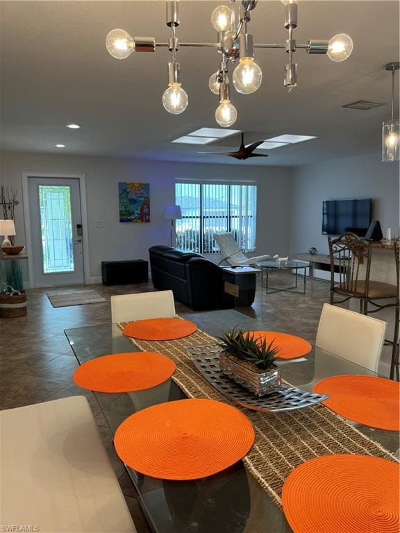 Tiled dining space featuring healthy amount of natural light and ceiling fan