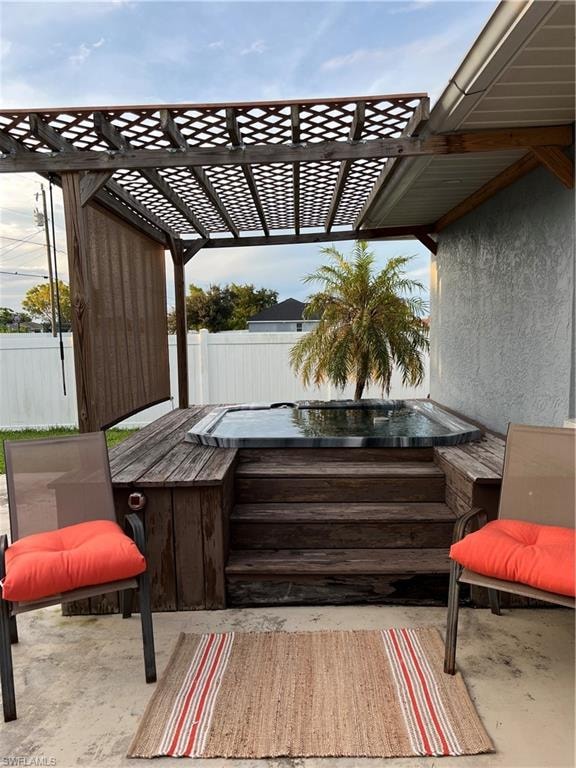 View of patio featuring an outdoor hot tub