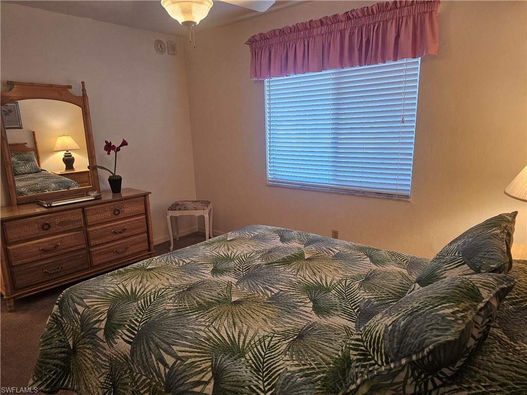 Bedroom featuring dark colored carpet