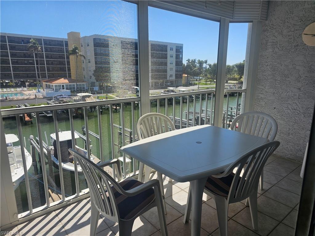 Balcony with a sunroom and a water view