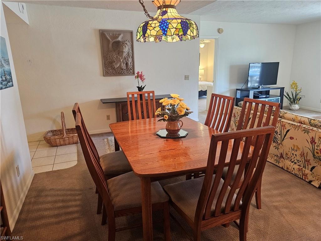 Dining space with carpet and tile patterned floors